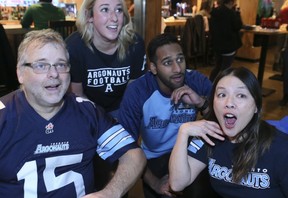 Toronto Argonauts fans cheer on their team at the Grey Cup on Sunday at Shoeless Joes on King St. From left to right,  Michael Gibson, Erin Wylie, Joe Anandjit and Bonnie Kim.