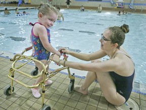 Madi Ambos, left, and Megan Sherwin at the Variety Village pool on Sunday, Nov. 19, 2017.