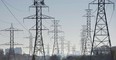 Hydro towers are seen over a golf course in Toronto.