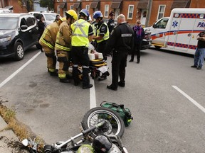 Emergency personnel in Peterborough tend to a motorcyclist after a recent mishap on the road.