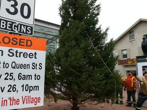 Work crews install the Christmas tree in Streetsville.