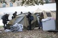 Volunteers assemble a tent at a harm-reduction site at Moss Park.