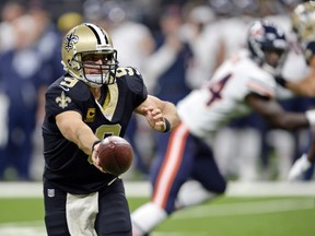 In this Oct. 29, 2017, file photo, New Orleans Saints quarterback Drew Brees hands off in the first half of an NFL football game against the Chicago Bears in New Orleans. (AP Photo/Bill Feig, File)