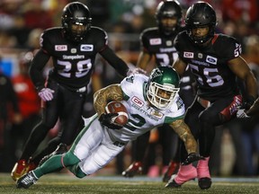 Long-time Argonaut Chad Owens, now a Roughrider, dives for extra yards against the Stampeders during a game in Calgary last month. (THE CANADIAN PRESS)