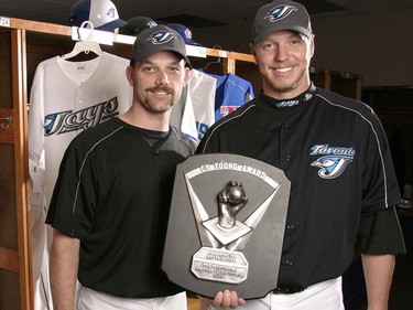 Pat Hentgen, left, and Roy Halladay pose with the 2003 Cy Young Award (Postmedia)