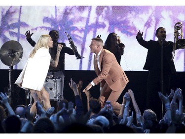 Macklemore, right, and Skylar Grey perform "Glorious" at the American Music Awards at the Microsoft Theater on Sunday, Nov. 19, 2017, in Los Angeles. (Photo by Matt Sayles/Invision/AP)