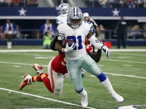 Dallas Cowboys running back Ezekiel Elliott (21) carries the ball as Kansas City Chiefs defensive end Allen Bailey, rear, attempts the stop in the first half of an NFL football game, Sunday, Nov. 5, 2017, in Arlington, Texas. (AP Photo/Michael Ainsworth)
