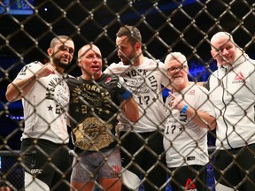 Georges St-Pierre of Canada celebrates with trainer Freddie Roach (R) following hs victory over Michael Bisping of England in their UFC middleweight championship bout during the UFC 217 event at Madison Square Garden on November 4, 2017 in New York City. (Photo by Mike Stobe/Getty Images)