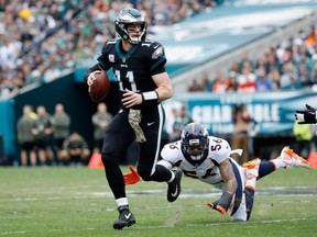Quarterback Carson Wentz #11 of the Philadelphia Eagles runs the ball against outside linebacker Shane Ray #56 of the Denver Broncos during the first quarter at Lincoln Financial Field on November 5, 2017 in Philadelphia, Pennsylvania.  (Photo by Joe Robbins/Getty Images)