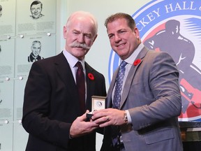 Chairman of the Hockey Hall of Fame Lanny McDonald presents Mark Recchi with the Hall ring during a media opportunity at the Hockey Hall Of Fame and Museum on November 10, 2017 in Toronto, Canada.  (Photo by Bruce Bennett/Getty Images)