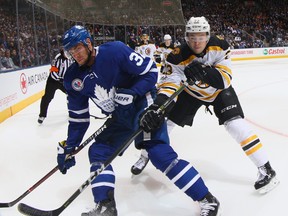 Frank Vatrano #72 of the Boston Bruins checks Josh Leivo #32 of the Toronto Maple Leafs during the second period at the Air Canada Centre on November 10, 2017 in Toronto, Canada.  (Photo by Bruce Bennett/Getty Images)