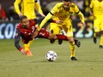 Justin Morrow #2 of the Toronto FC is knocked down by Artur #7 of the Columbus Crew SC while chasing after a loose ball during the first half at MAPFRE Stadium on November 21, 2017 in Columbus, Ohio. (Photo by Kirk Irwin/Getty Images)