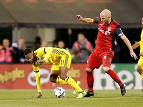 Ola Kamara #11 of the Columbus Crew SC loses his balance while battling for control of the ball with Michael Bradley #4 of the Toronto FC during the second half at MAPFRE Stadium on November 21, 2017 in Columbus, Ohio. Columbus tied Toronto 0-0. (Kirk Irwin/Getty Images)
