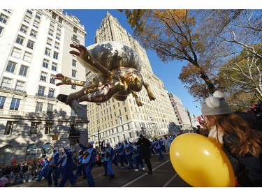 A young girl watches The Ice Age Scrat balloon float by during the 91st Annual Macy's Thanksgiving Day Parade on Nov. 23, 2017 in New York City.  (Michael Loccisano/Getty Images)