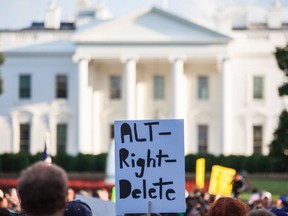 A demonstrator holds a sign in front of the White House August 13, 2017 in Washington, DC, during a vigil in response to the death of a counter-protestor in the August 12th "Unite the Right" rally that turned violent in Charlottesville, Virginia.