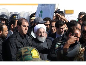 A handout photo provided by the office of Iranian President Hassan Rouhani shows him (C) during visit to the earthquake-hit area of Sarpol-e Zahab in Iran's western province of Kermanshah, where he promised on November 14, 2017 that the government would move swiftly to help those left homeless by the disaster. Tens of thousands of Iranians spent a second night in the open after a 7.3-magnitude quake struck near the border with Iraq, killing more than 400 people. (Handout photo/AFP/Getty Images)