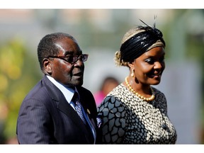 This file photo taken on May 24, 2014 shows Zimbabwean President Robert Mugabe (L) arriving with his wife Grace for the inauguration ceremony of South African President at the Union Buildings in Pretoria. Robert Mugabe has been removed as president of Zimbabwe's ruling ZANU-PF party and replaced by his former vice president, a party delegate told AFP on November 19, 2017 outside a meeting in Harare. Grace Mugabe was also expelled from Zimbabwe's ruling ZANU-PF according to party official.  (SIPHIWE SIBEKO/AFP/Getty Images)