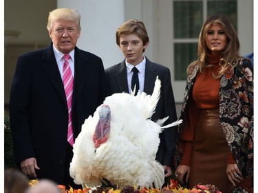 U.S. President Donald Trump, first lady Melania Trump (R) and their son Barron look on after Trump pardoned the turkey, Drumstick, during the ceremony at the White House in Washington, D.C., on Nov. 21, 2017. (ANDREW CABALLERO-REYNOLDS/AFP/Getty Images)