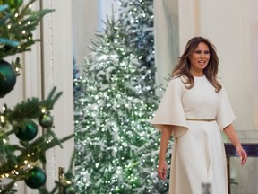 US First Lady Melania Trump walks into the East Room as she tours Christmas decorations at the White House in Washington, DC, November 27, 2017.