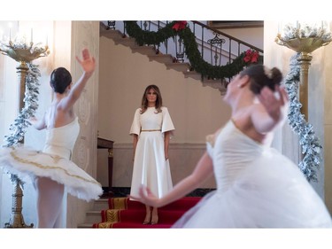 US First Lady Melania Trump watches ballerinas perform in the Grand Foyer as she tours Christmas decorations at the White House in Washington, DC, November 27, 2017. SAUL LOEB/AFP/Getty Images