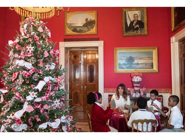 US First Lady Melania Trump speaks with children as they make holiday decorations in the Red Room as she tours Christmas decorations at the White House in Washington, DC, November 27, 2017. SAUL LOEB/AFP/Getty Images