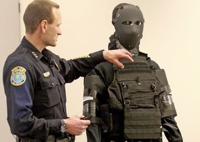 Police Chief Eric Jewkes describes the amount of body armor worn using a display of the actual body armor used by suspect Matthew Stover during a Fairbanks Police Department press briefing Thursday afternoon, Nov. 2, 2017 in Fairbanks, Alaska.  The man who was killed in June after firing at officers came prepared to kill, not die, wearing a bullet-proof mask and dressed head to toe in modified body armor, Fairbanks Police Chief Eric Jewkes said. (Eric Engman/Fairbanks Daily News-Miner via AP)