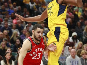 Toronto Raptors guard Fred VanVleet (23) pushes his way around Indiana Pacers centre Myles Turner during the first half of Friday's Raptors loss in Indianapolis. THE ASSOCIATED PRESS
