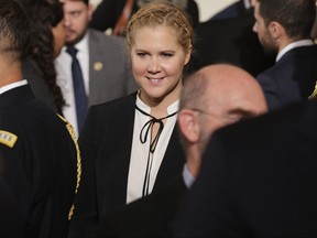 Comedian Amy Schumer (C) poses for photographs with victims of gun violence, their family and supporters after U.S. President Barack Obama delivered remarks about his efforts to increase federal gun control in the East Room of the White House January 5, 2016 in Washington, DC.  (Chip Somodevilla/Getty Images)