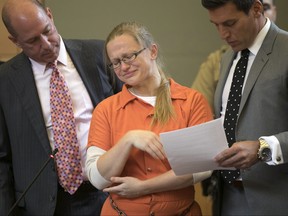 Attorneys flank Angelika Graswald (centre) as she cries after pleading guilty to criminally negligent homicide in the kayak-related death of her fiance Vincent Viafore, in Goshen, N.Y., on July 24, 2017. Graswald was sentenced Wednesday, Nov. 8, to up to four years in state prison. (Allyse Pulliam/Times Herald-Record via AP/Pool)