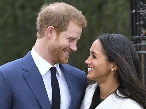 Britain’s Prince Harry and Meghan Markle smile as they pose for the media in the grounds of Kensington Palace in London, Monday Nov. 27, 2017.(Dominic Lipinski/PA via AP)