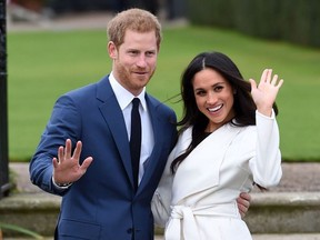 Britain's Prince Harry and Meghan Markle pose for the media in the grounds of Kensington Palace in London, Monday Nov. 27, 2017.