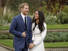 Britain’s Prince Harry and his fiancee Meghan Markle pose for photographers during a photocall in the grounds of Kensington Palace in London, Monday Nov. 27, 2017. (AP Photo/Matt Dunham)
