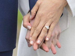 Meghan Markle wears her engagement ring as she poses with Britain’s Prince Harry for the media in the grounds of Kensington Palace in London, Monday Nov. 27, 2017. (Dominic Lipinski/PA via AP)