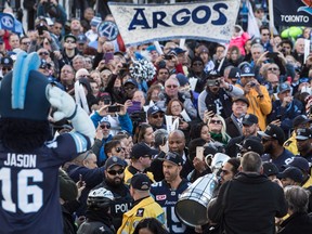 Toronto Argonauts Marcus Ball holds the Grey Cup with Ricky Ray in Toronto's Nathan Phillips Square on Nov. 28, 2017