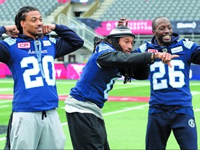Toronto Argonauts defenders Rico Murray, from left to right, Johnny Sears Jr. and  Cassius Vaughn joke around for photographers during practice in Ottawa on Saturday, November 25, 2017. The Toronto Argonauts will play the Calgary Stampeders in the 105th Grey Cup. THE CANADIAN PRESS/Nathan Denette