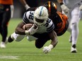 Toronto Argonauts' James Wilder Jr. is tackled by BC Lions' Mic'hael Brooks during CFL action on Nov. 4, 2017
