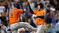 Houston Astros' George Springer (right) celebrates with Marwin Gonzalez after hitting a two-run home run during the second inning against the Los Angeles Dodgers in Game 7 of the 2017 World Series at Dodger Stadium on Nov. 1, 2017 in Los Angeles.  (Ezra Shaw/Getty Images)