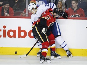 Toronto Maple Leafs' William Nylander, left, tries to get past Calgary Flames' Matt Stajan during second period NHL hockey action in Calgary, Nov. 28, 2017. (JEFF McINTOSH/The Canadian Press)