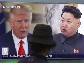 FILE - In this Aug. 10, 2017, file photo, a man watches a TV screen showing U.S. President Donald Trump and North Korean leader Kim Jong Un, right, during a news program at the Seoul Train Station in Seoul, South Korea. With all the verbal barbs flying between Kim Jong Un and U.S. President Donald Trump these days, China's decision to send its most senior official to North Korea in more than two years could be a welcome opportunity to defuse the growing tensions between Washington and Pyongyang. (AP Photo/Ahn Young-joon, File)