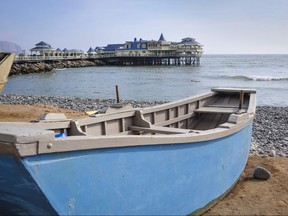 A boat rests on the beach in the Miraflores district of Lima. Peru's capital city has been attracting more tourists in recent years.