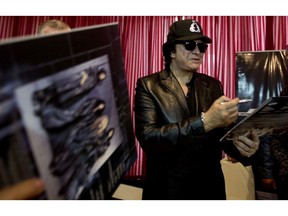 KISS frontman Gene Simmons signs autographs at the end of a press conference in La Paz, Bolivia, Friday, Oct. 20, 2017. Simmons is in the South American country to take part in the weekend rock and metal music festival, "Scream Bolivia." (AP Photo/Juan Karita)