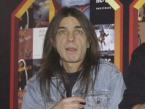 A March 3, 2003 file photo of AC/DC co-founder and guitarist Malcolm Young at an event in London. The band has announced, Saturday Nov. 18, 2017,  that 64-year-old Young has died. (Yui Mok/PA via AP)