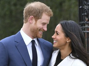 Britain’s Prince Harry and Meghan Markle smile as they pose for the media in the grounds of Kensington Palace in London, Monday Nov. 27, 2017. It was announced Monday that Prince Harry, fifth in line for the British throne, will marry American actress Meghan Markle in the spring, confirming months of rumors. (Dominic Lipinski/PA via AP) ORG XMIT: LON822
