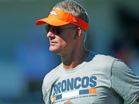 In this July 27, 2017, file photo, Denver Broncos offensive coordinator Mike McCoy takes part in drills during an NFL football training camp