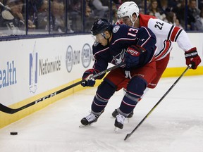 Columbus Blue Jackets' Cam Atkinson, left, carries the puck behind the net on Nov. 10, 2017