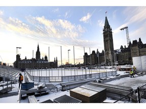 Construction continues on the skating rink on Parliament Hill in Ottawa on Monday, Nov. 20, 2017. A $5.6-million skating rink constructed on the east lawn of Parliament Hill will remain open to the public until the end of February - not just for three weeks as initially planned. (THE CANADIAN PRESS/Justin Tang)