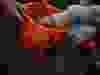 Cropped Image Of Hands Picking Candy From Halloween Basket