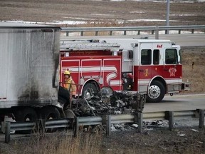 Fire and police officials on the scene of a fatal transport fire on westbound Highway 402, south of Sarnia, on Jan. 31, 2016. Gurpreet Brar was found dead inside.(BARBARA SIMPSON/Sarnia Observer/Postmedia Network)