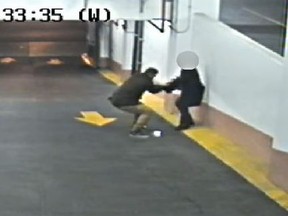 A woman struggles with a man trying to steal her purse in a Bay-College parking garage on Friday, Nov. 17, 2017.