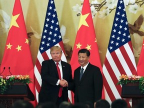 U.S. President Donald Trump, left, poses with Chinese President Xi Jinping for a photo after a joint press conference at the Great Hall of the People in Beijing, Thursday, Nov. 9, 2017.